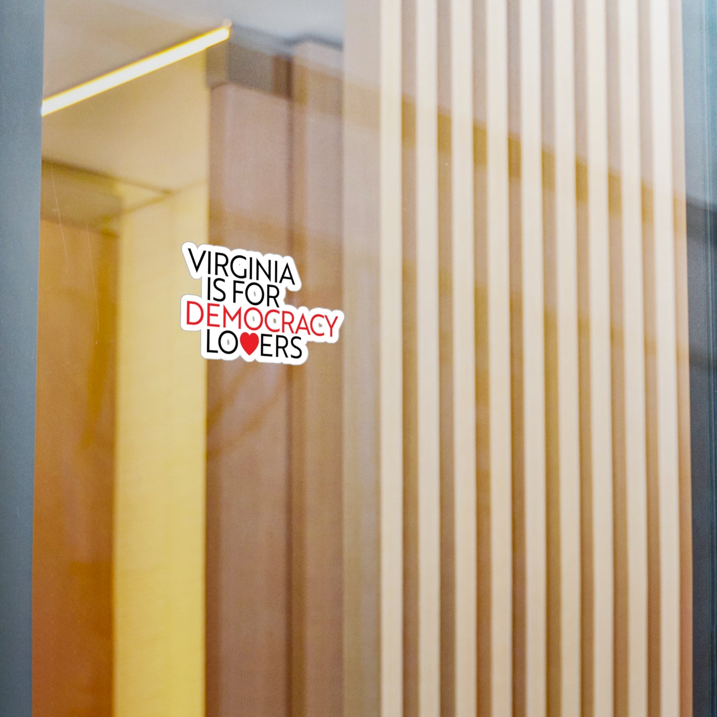 Sticker with 'Virginia is for Democracy Lovers' text on a glass door.