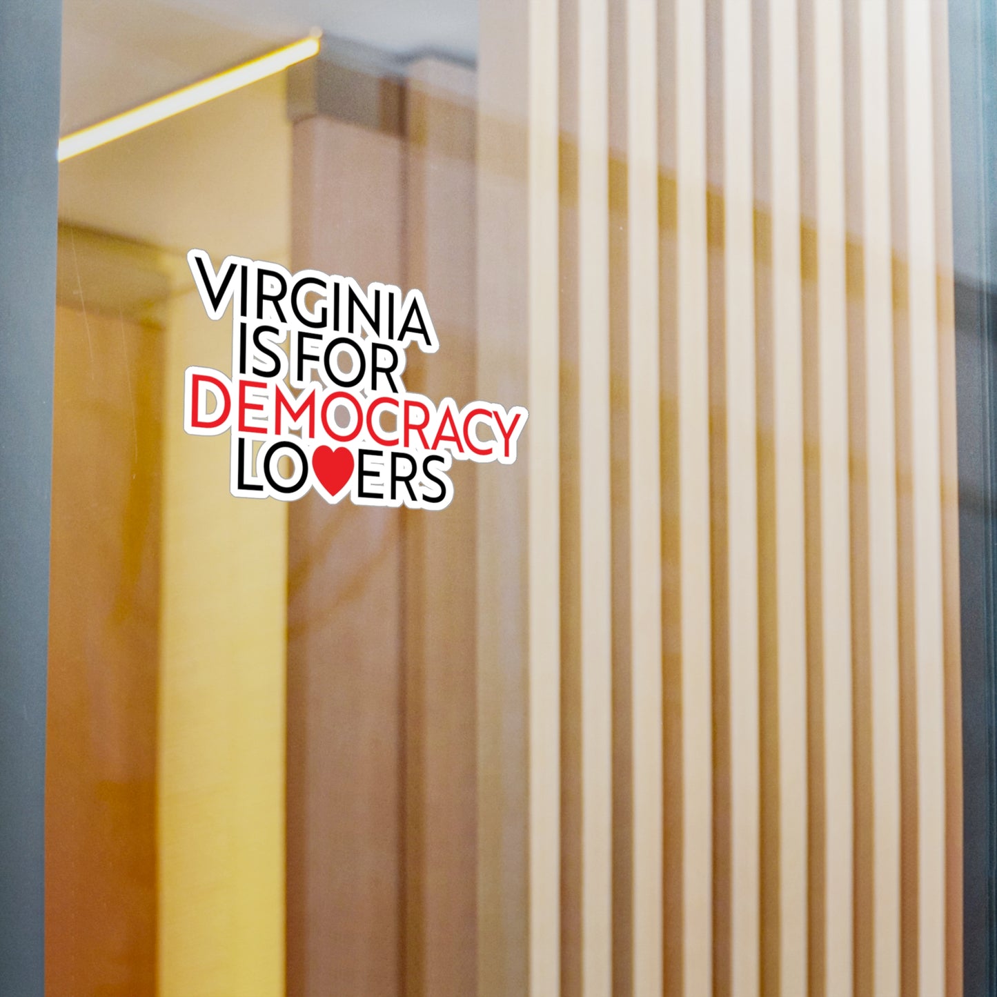 Decorative window sticker with 'Virginia is for Democracy Lovers' text on a glass door.
