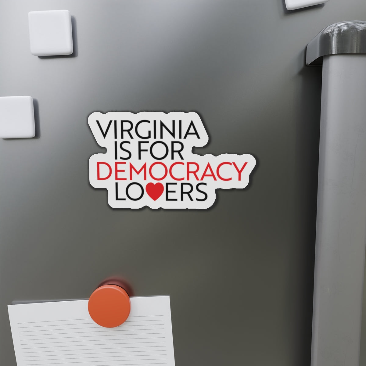 Magnet on a refrigerator door with text 'Virginia is for Democracy Lovers' and a heart symbol.