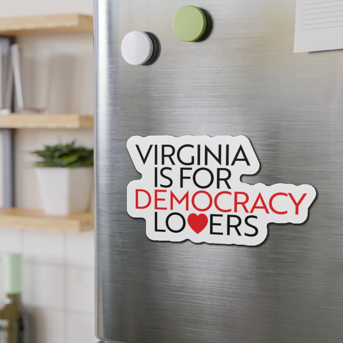 Magnet on a refrigerator with text 'Virginia is for Democracy Lovers' in a home setting.