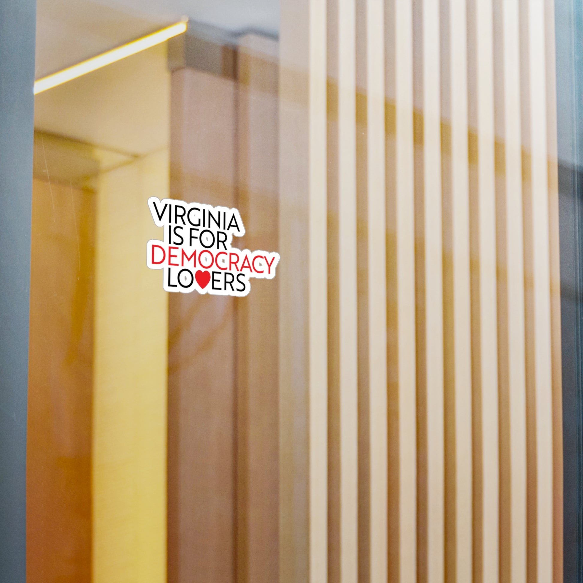 Sticker with 'Virginia is for Democracy Lovers' text on a glass door.
