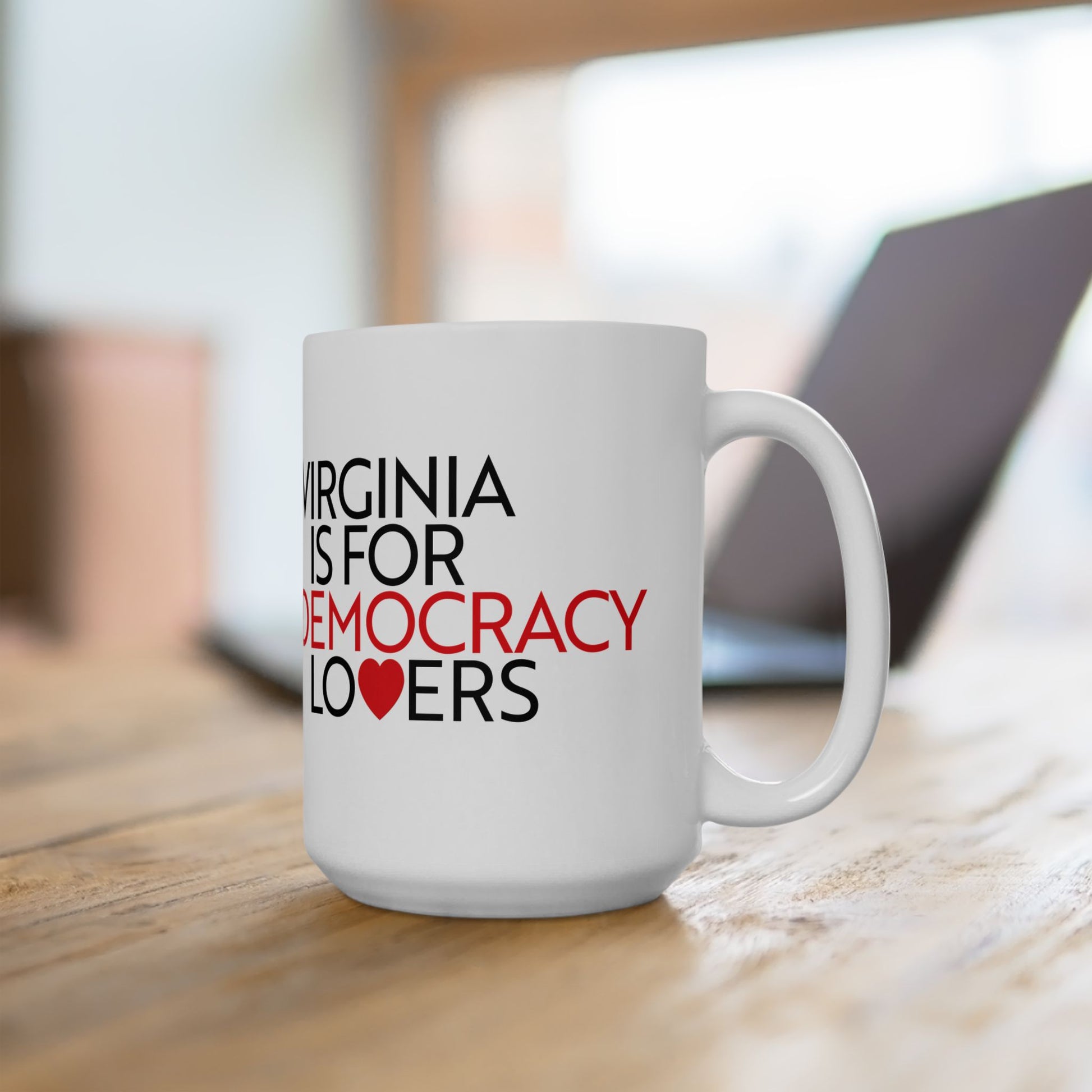 White mug with text 'Virginia is for Democracy Lovers' on a wooden surface.