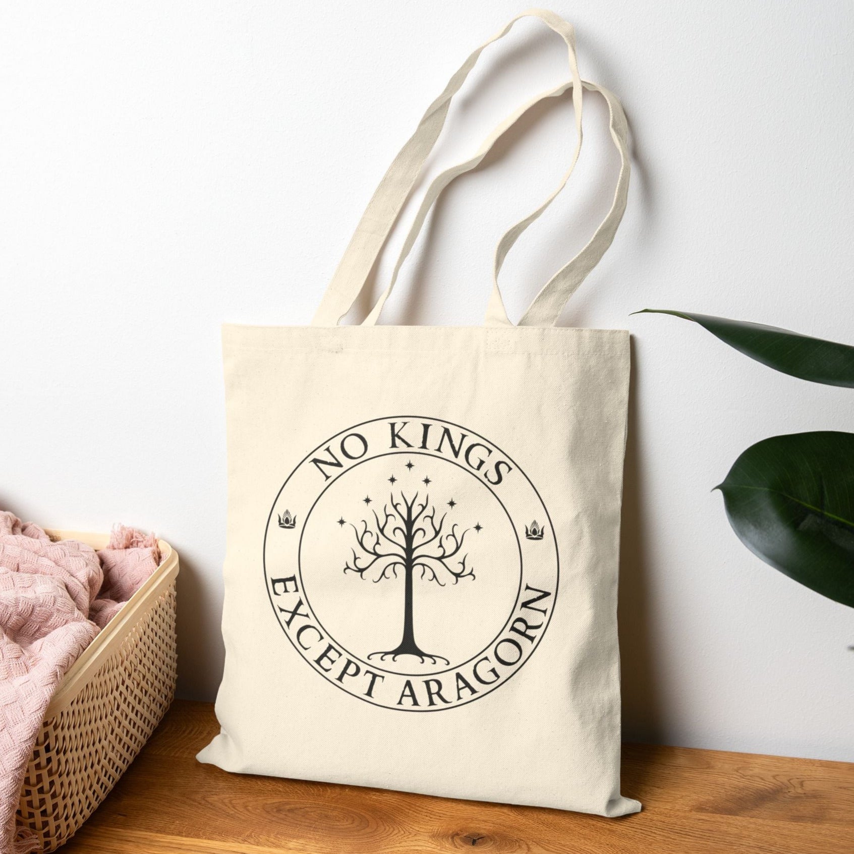 A tan tote back with the text "No kings except Aragorn" and a graphic f a tree with seven stars above it and two crowns of the king of Gondor.