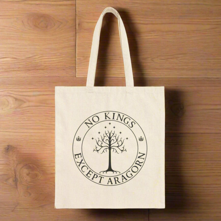 A tan tote back with the text "No kings except Aragorn" and a graphic f a tree with seven stars above it and two crowns of the king of Gondor.