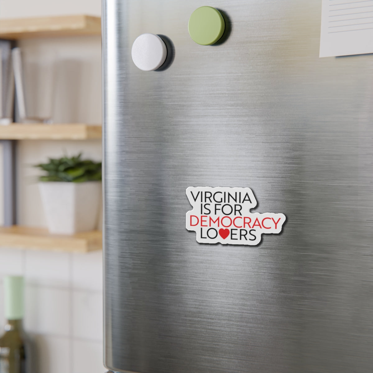 Fridge with a magnet that reads 'Virginia is for democracy lovers' on a metallic surface.