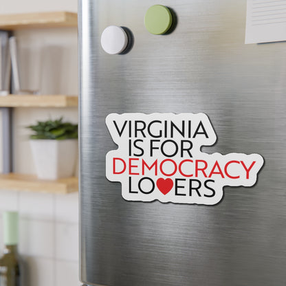 Magnet on a refrigerator with text 'Virginia is for Democracy Lovers' in a home setting.