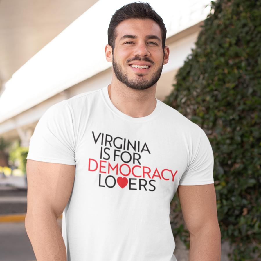 Man wearing a white t-shirt with 'Virginia is for Democracy Lovers' text, standing outdoors.
