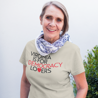 Woman wearing a t-shirt with 'Virginia is for Democracy Lovers' text, standing outdoors.