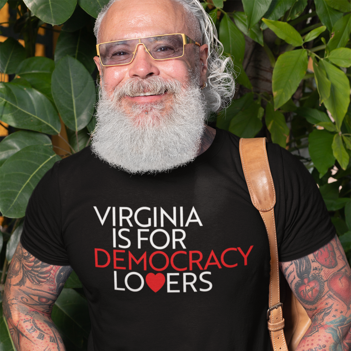 Man wearing a black t-shirt with 'Virginia is for Democracy Lovers' text, standing outdoors.