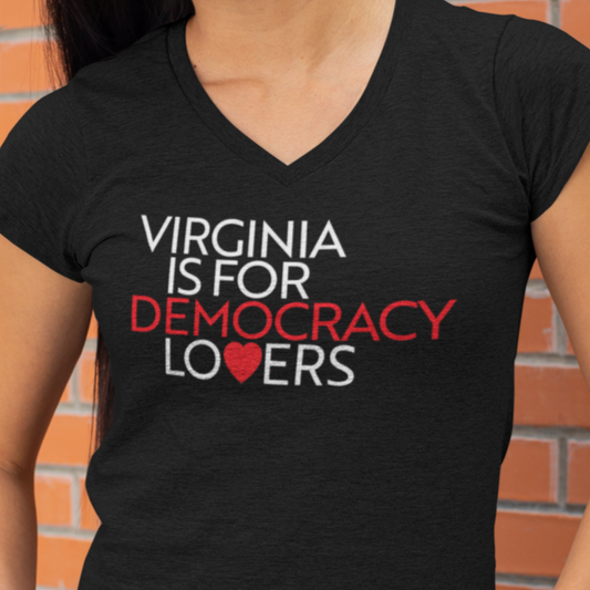 Black t-shirt with 'Virginia is for Democracy Lovers' text and heart graphic against a brick wall.